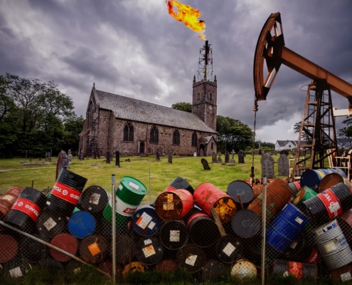 Image of a church with oil barrels and flare