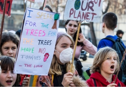 Protestors with banners at a Youth strike for climate march in central London