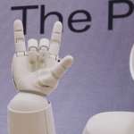 A robot raises a hand