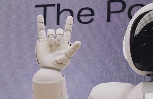 A robot raises a hand