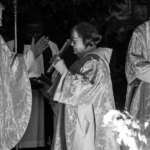 Bishop Steven standing beside a fire at Christ Church Cathedral on Easter Eve.