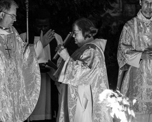 Bishop Steven standing beside a fire at Christ Church Cathedral on Easter Eve.