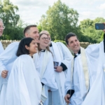 Newly ordained priests take a selfie with Bishop Steven
