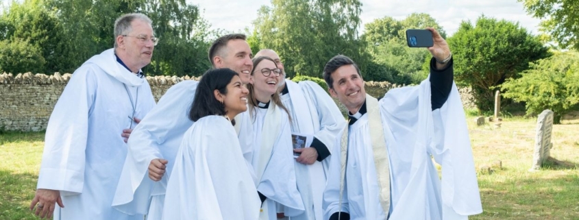 Newly ordained priests take a selfie with Bishop Steven